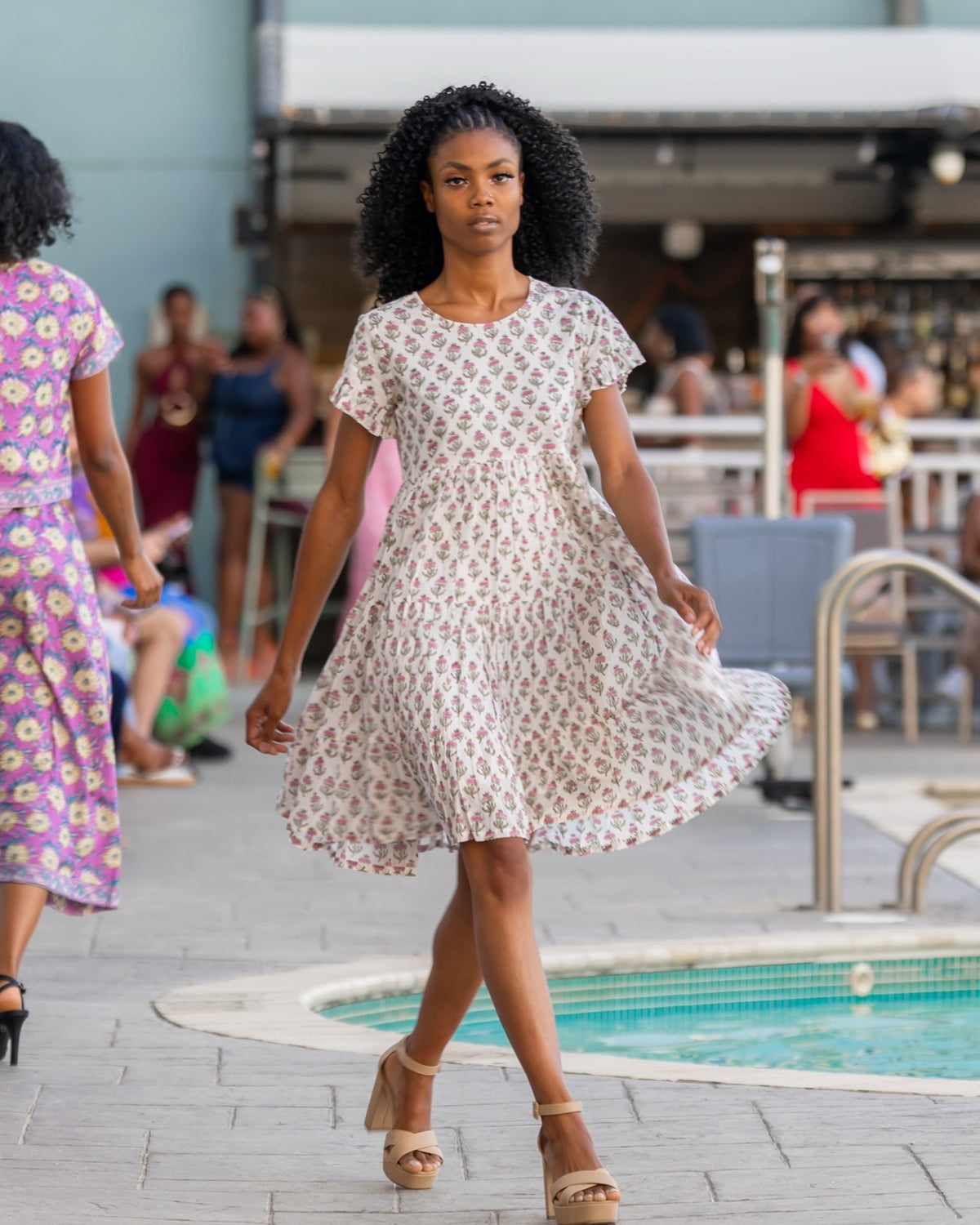 Anna Dress – hand block-printed cream floral tiered cotton dress, runway front view, mid-stride