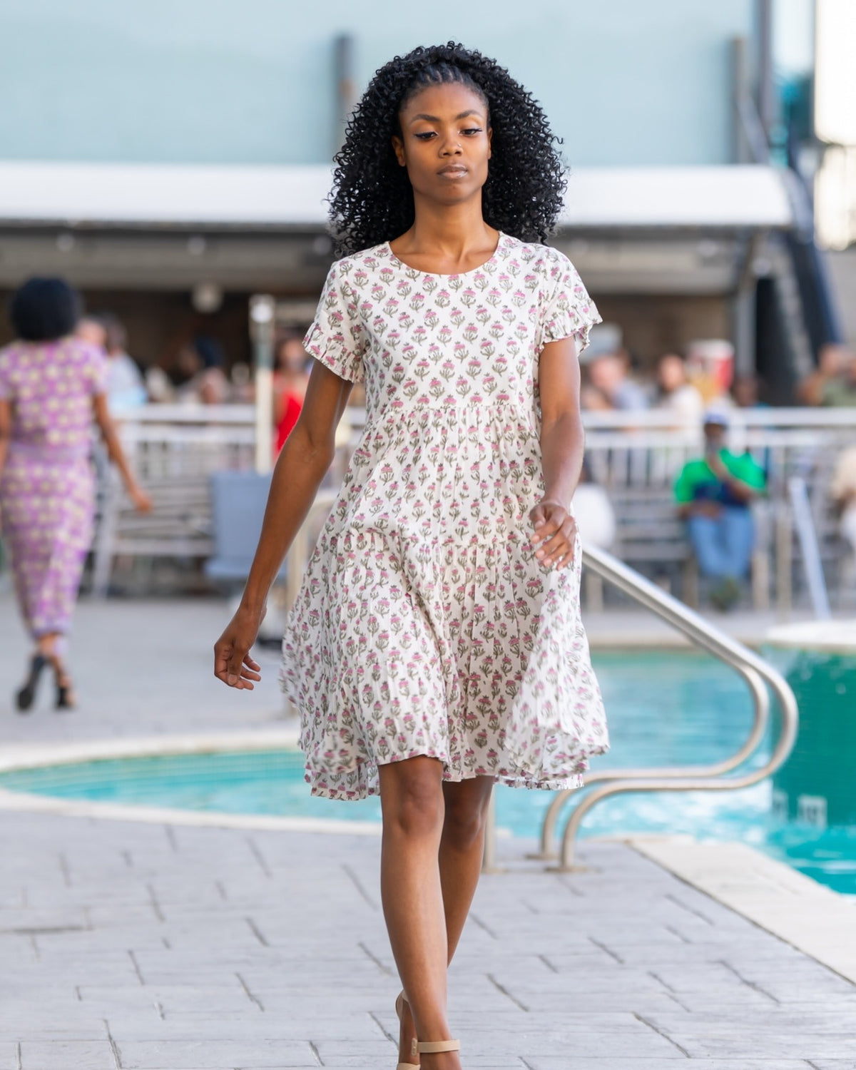Anna Dress – hand block-printed cream floral tiered cotton dress, runway front view walking