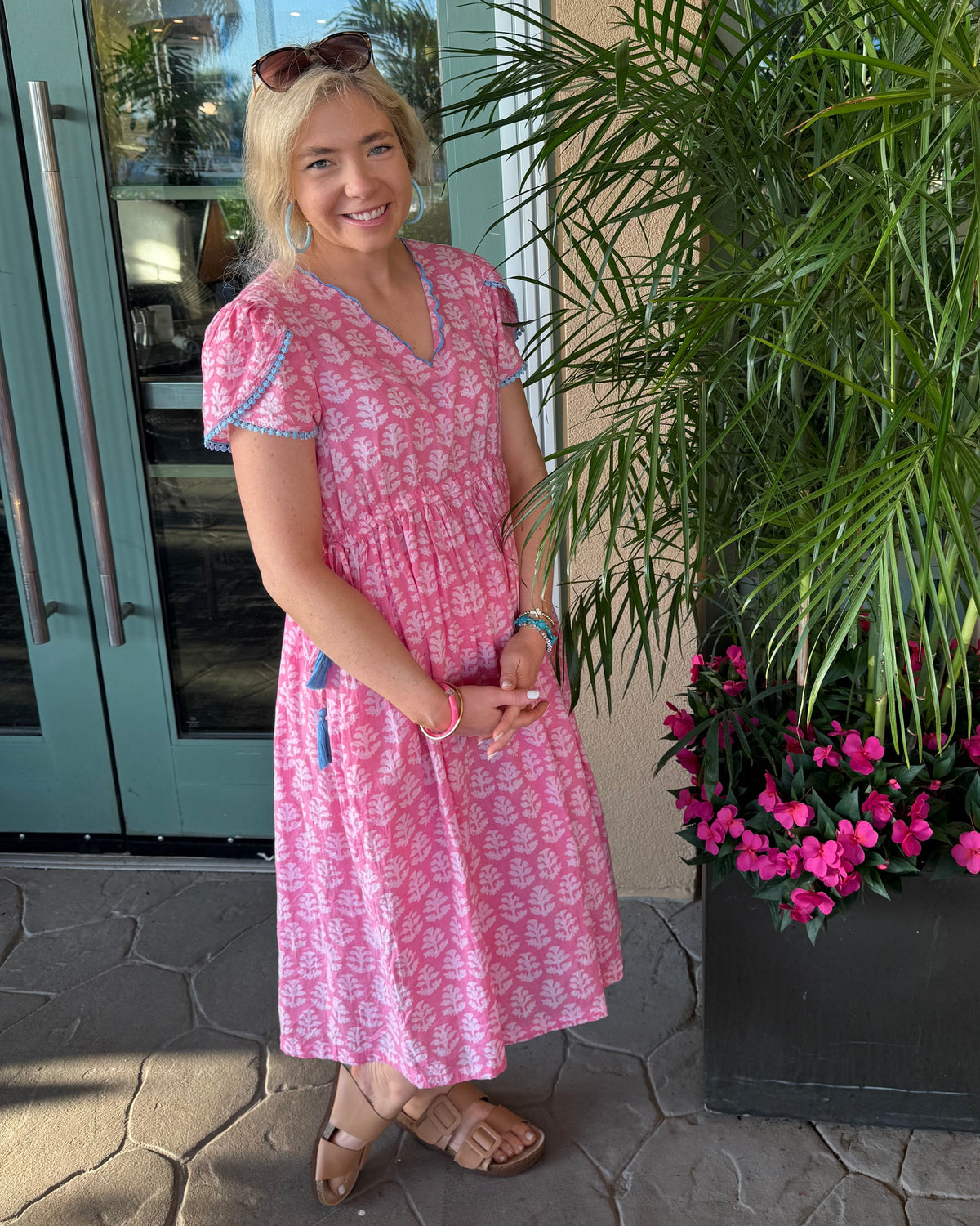 Candy Dress – hand block-printed pink cotton midi dress with short puff sleeves, V-neck and blue trim, full-length front view